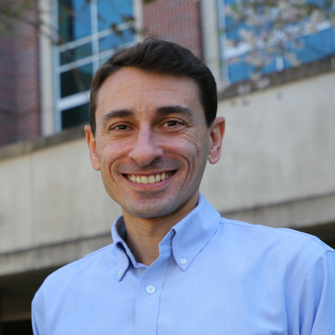 Close up of James Wray smiling and wearing a light blue shirt