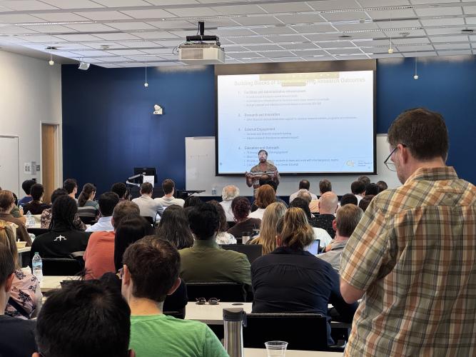 Executive Director Jud Ready presenting inside a room at the Marcus Nanotechnology Building for SRI's inaugural meeting.